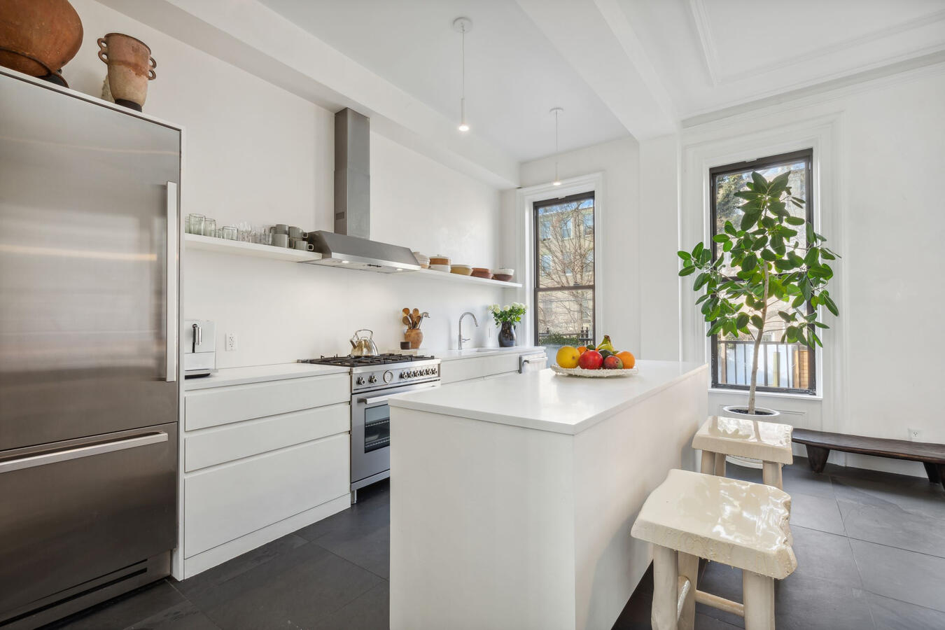 Open kitchen with large cabinets, sleek center island, updated Bertazzoni stainless steel appliances