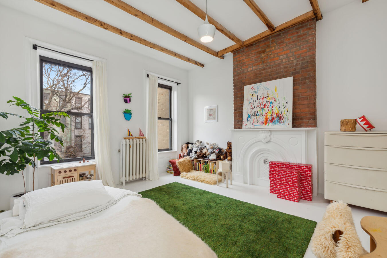 Another guest bedroom with exposed wood beams and ample closet space.